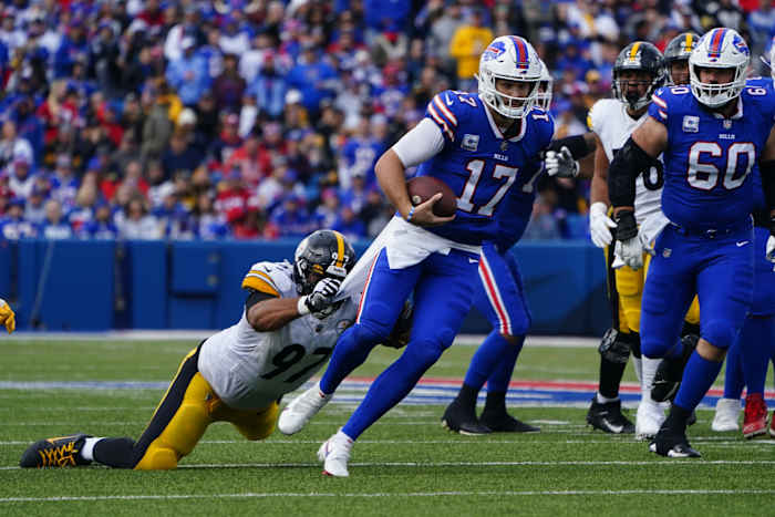 Bills quarterback Josh Allen escapes Steelers defender Cameron Heyward.